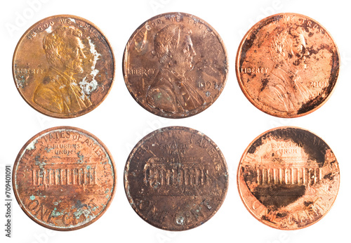 Isolated photo of old rusty worn american 1 cent coins on white background.