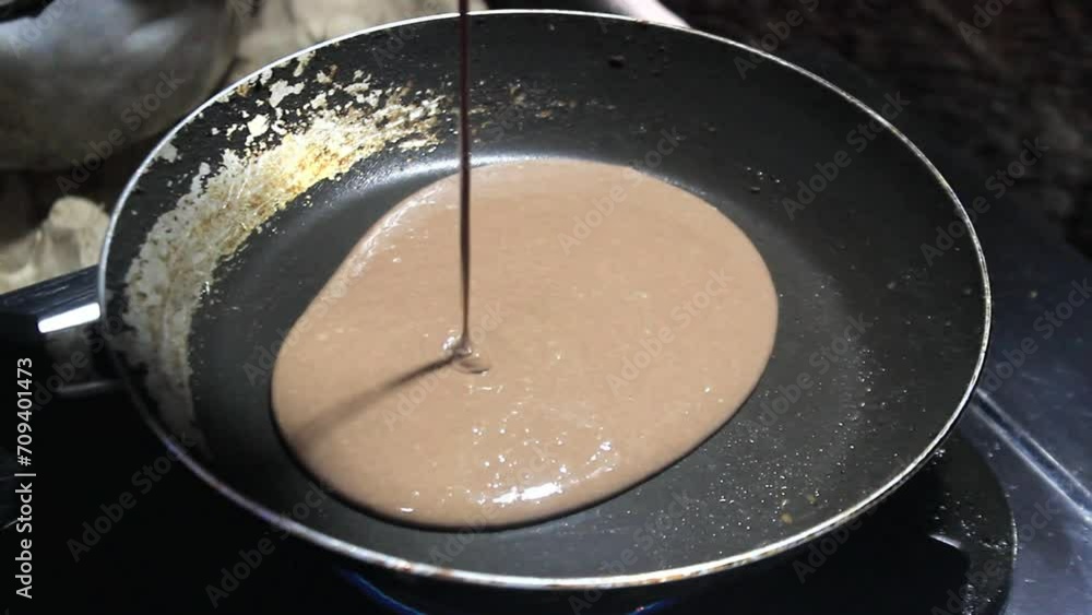 the process of cooking chocolate cake on a frying pan over medium heat the process of cooking chocolate cake on a frying pan over medium heat