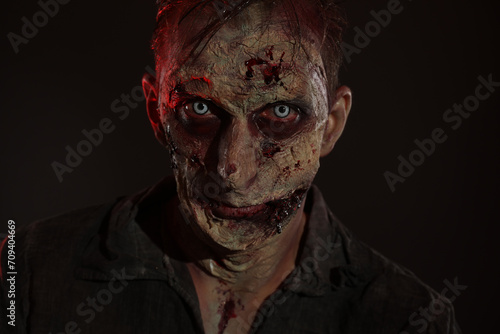 Scary zombie on dark background. Halloween monster