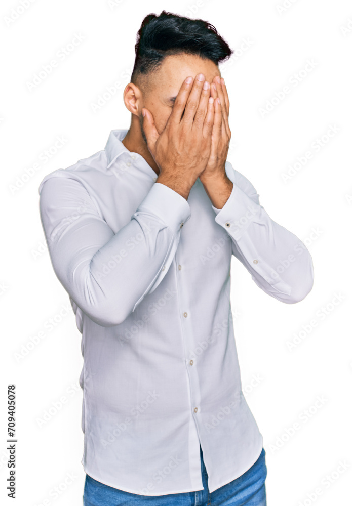 Young arab man wearing casual clothes with sad expression covering face with hands while crying. depression concept. Young arab man wearing casual clothes with sad expression covering face with hands while crying. depression concept.