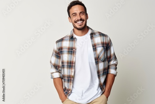 Portrait of handsome young man in checkered shirt smiling at camera