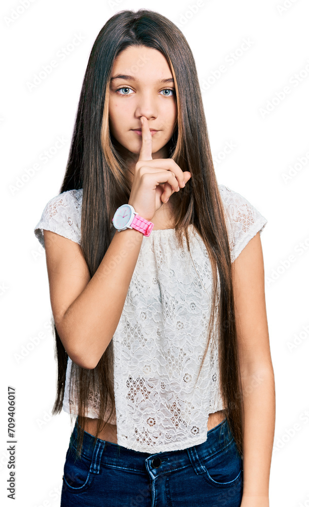 Young brunette girl with long hair wearing white shirt asking to be quiet with finger on lips. silence and secret concept. Young brunette girl with long hair wearing white shirt asking to be quiet with finger on lips. silence and secret concept.