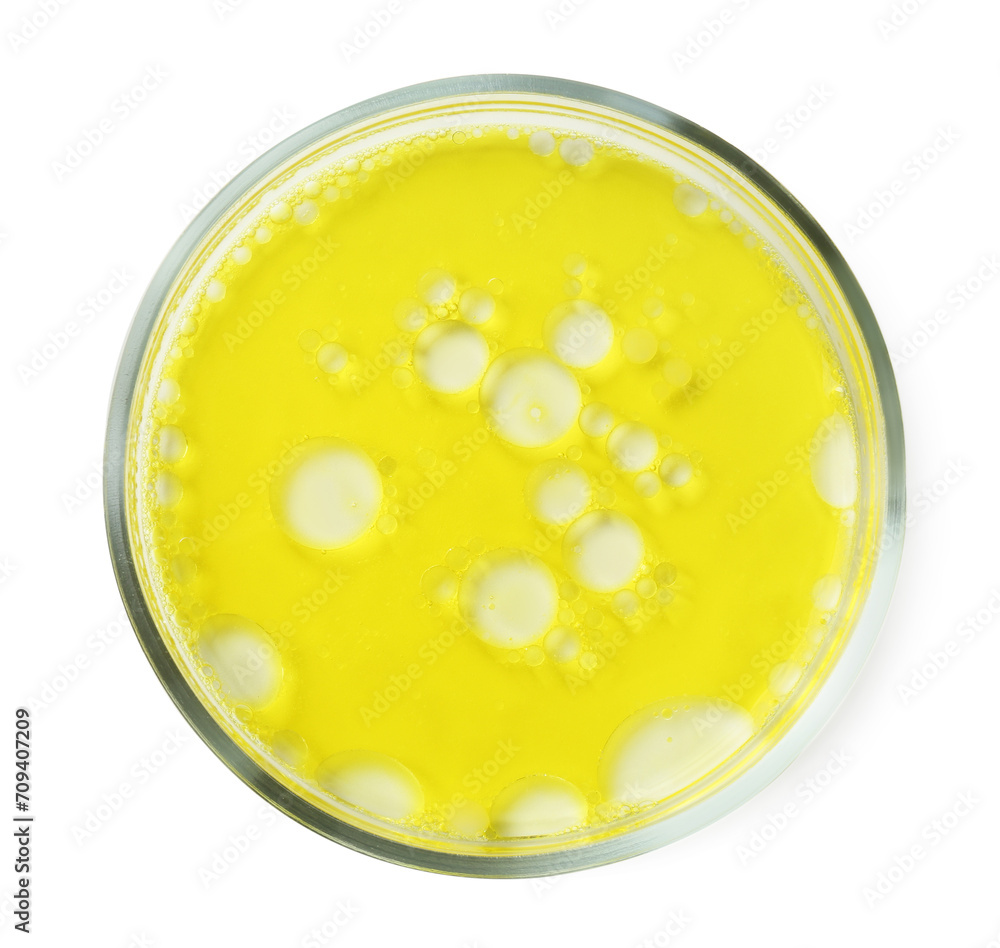 Petri dish with yellow liquid sample on white background, top view Petri dish with yellow liquid sample on white background, top view