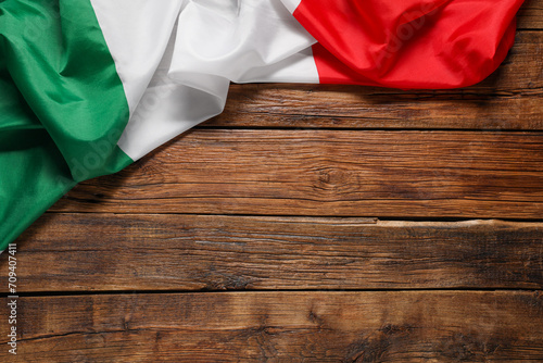 Flag of Italy on wooden background, top view. Space for text