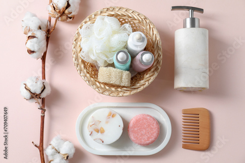 Bath accessories. Flat lay composition with personal care products on pink background