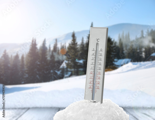 Thermometer in snow showing temperature below zero outdoors on winter day