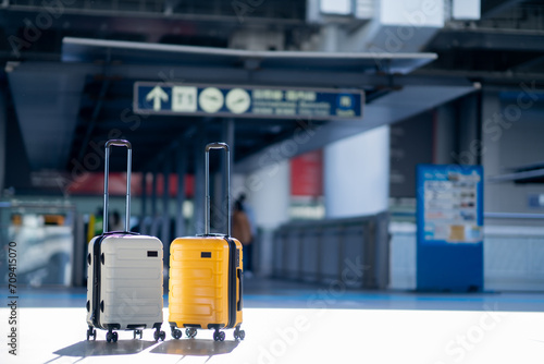 Two suitcases in an empty airport hall  traveler cases in the departure airport terminal waiting for the area  vacation concept  blank space for text message or design