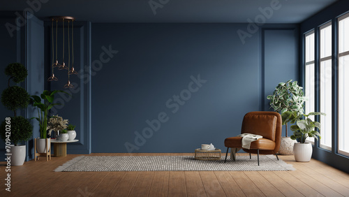 Modern interior of living room with leather armchair on wood flooring and dark blue wall photo