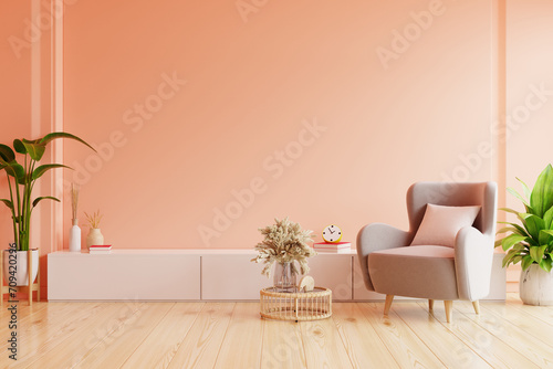 Modern living room. peach fuzz room have peach armchair with peach color paint wall photo