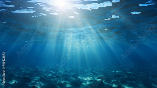 beautiful underwater scene with sunbeams under the ripples ocean water surface © Aura