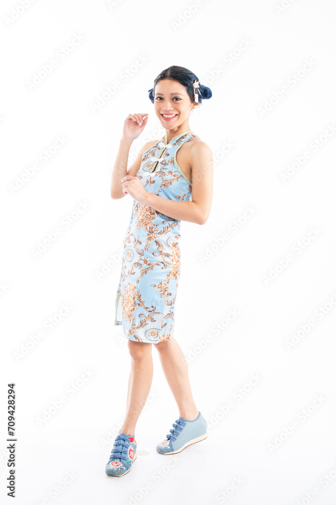 Portrait of an attractive Asian Chinese female wearing cheongsam or qipao isolated on white background for Chinese New Year concept Portrait of an attractive Asian Chinese female wearing cheongsam or qipao isolated on white background for Chinese New Year concept