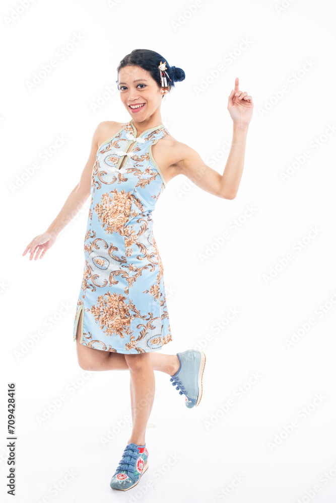 Portrait of an attractive Asian Chinese female wearing cheongsam or qipao isolated on white background for Chinese New Year concept Portrait of an attractive Asian Chinese female wearing cheongsam or qipao isolated on white background for Chinese New Year concept