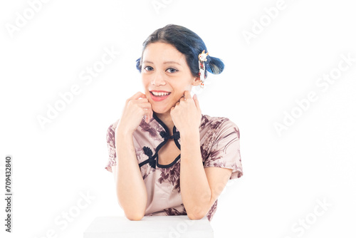 Closeup portrait of an attractive Asian Chinese female wearing cheongsam or qipao isolated on white background for Chinese New Year concept