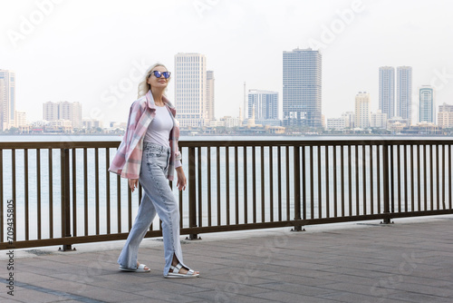  cheerful mature lady walking at seaside promenade