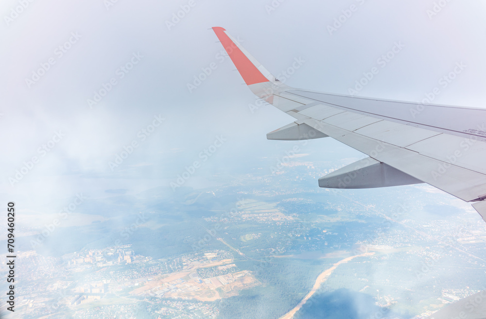 Fototapeta premium View from the airplane window during taking off on a clear summer morning