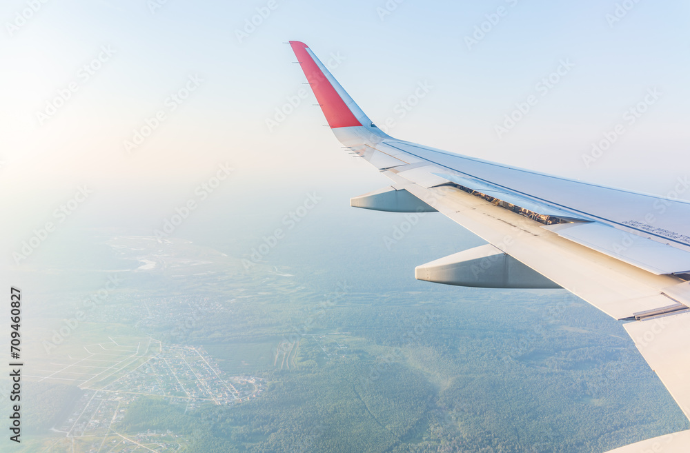 Obraz premium View from the airplane window at a beautiful cloudy sky and the airplane wing