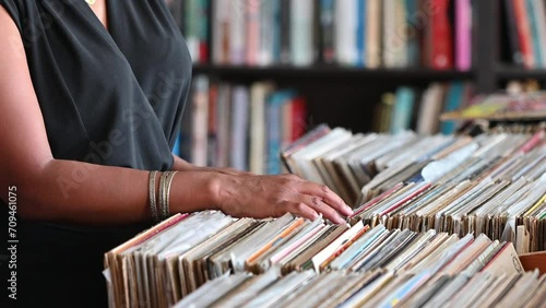 View of woman seen searching through vinyl records