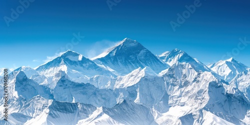 Dramatic mountain range covered in snow with a clear blue sky © DailyStock