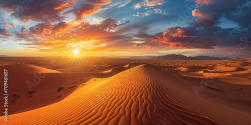 panoramic view of a vast desert under a blazing sunset, with sand dunes creating beautiful patterns.