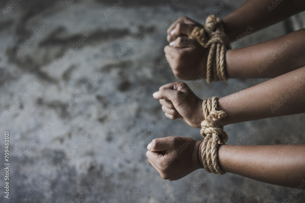 Victim boy with hands tied up with rope in emotional stress and pain,   Stop violence against children and trafficking Concept.