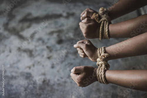 Victim boy with hands tied up with rope in emotional stress and pain,   Stop violence against children and trafficking Concept. photo