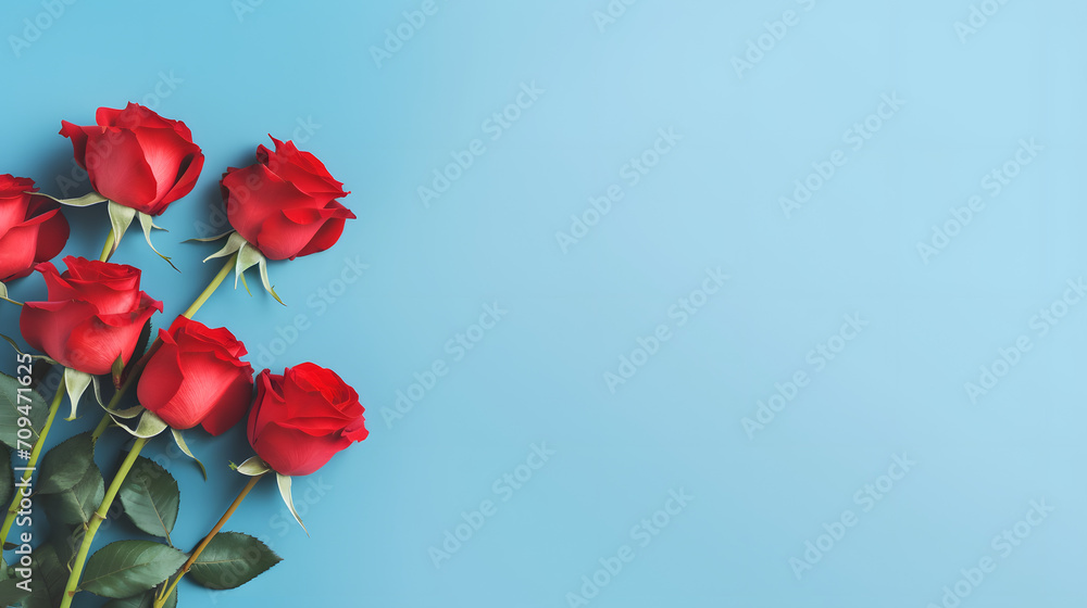 Obraz premium Red roses mock up banner on soft blue desktop background, top view. Layout for Valentines day, dating and love greeting card, anniversary and invitations. Retro styled, Bright color