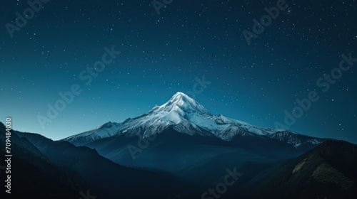 Aerial view of a lone, snow-capped mountain peak, at starry night