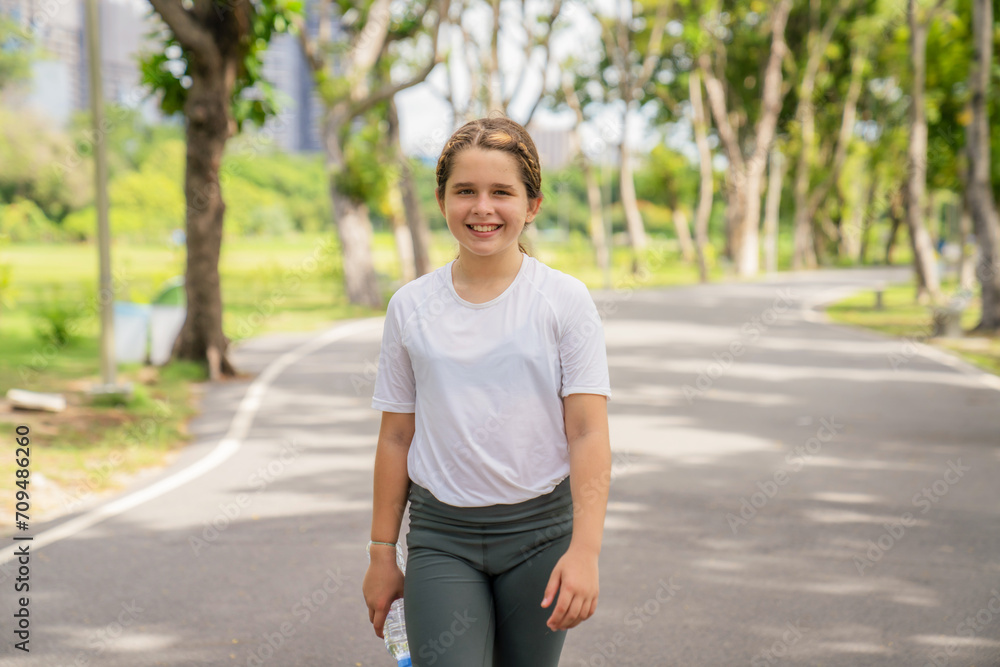 Cute little girl playing and jogging at the city park. Have fun and enjoy living outdoors during the summer holidays. Cute little girl playing and jogging at the city park. Have fun and enjoy living outdoors during the summer holidays.