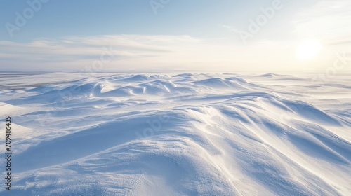 Winter landscape with snowdrifts and blue sky.