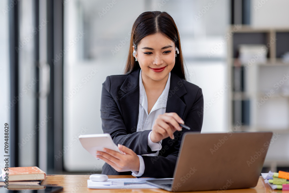 Asian businessman hand using calculator and working with laptop calculate about finance accounting at workplace.finance accounting concept Asian businessman hand using calculator and working with laptop calculate about finance accounting at workplace.finance accounting concept