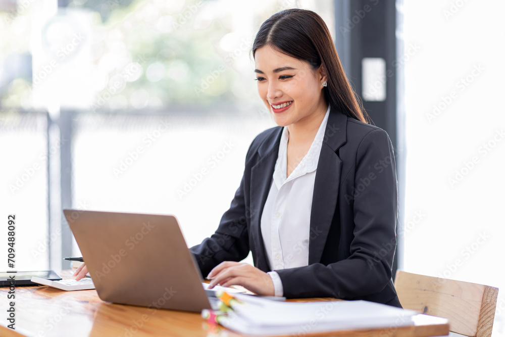 Asian businessman hand using calculator and working with laptop calculate about finance accounting at workplace.finance accounting concept Asian businessman hand using calculator and working with laptop calculate about finance accounting at workplace.finance accounting concept
