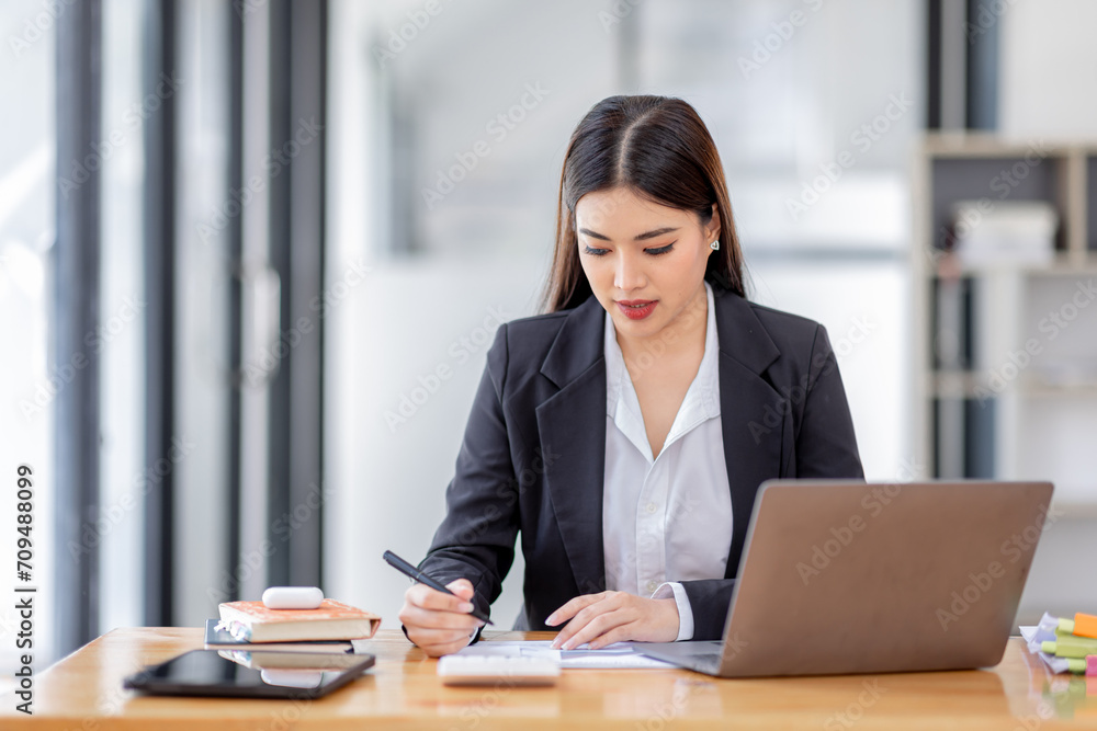 Asian businessman hand using calculator and working with laptop calculate about finance accounting at workplace.finance accounting concept Asian businessman hand using calculator and working with laptop calculate about finance accounting at workplace.finance accounting concept
