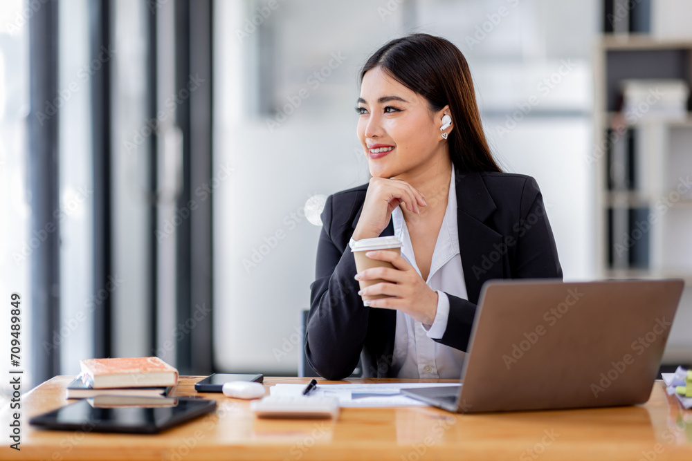 Portrait of Asian business woman holding coffee cup with work in workplace office Business documents money financial planning concept
Portrait of Asian business woman holding coffee cup with work in workplace office Business documents money financial planning concept
