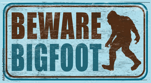 Aged and worn bigfoot sign on wood