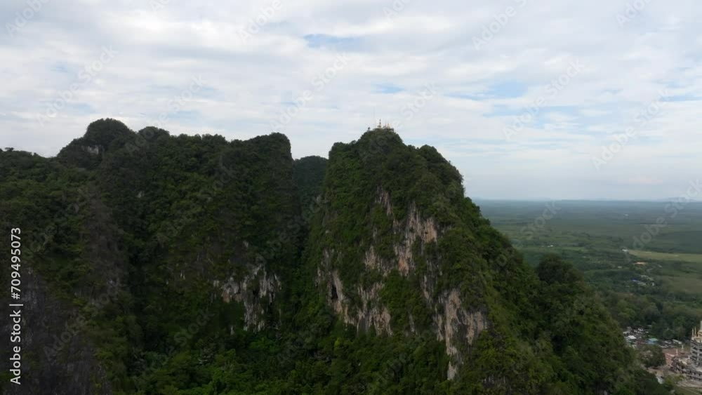 Golden Buddha statue at Tiger Cave Temple Wat Tham Sua in Krabi Thailand. Footage filmed from the sky in 4k Golden Buddha statue at Tiger Cave Temple Wat Tham Sua in Krabi Thailand. Footage filmed from the sky in 4k