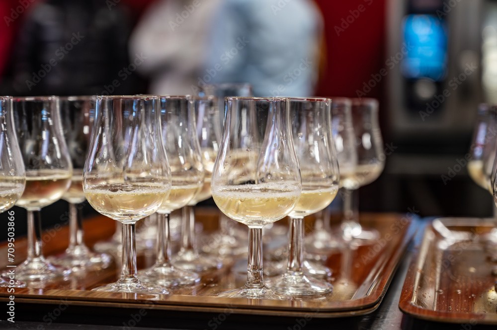 Obraz premium Many small tasting glasses of sparkling wine champagne on winter festival in December, Avenue de Champagne, Epernay, Champagne region, France