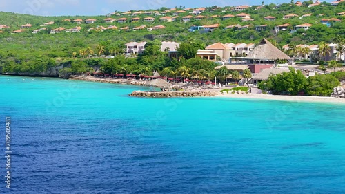 Stunning blue Caribbean waters with cabanna villas on coast of tropical island photo