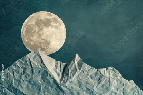 full moon illuminating the night sky above a rugged mountain range