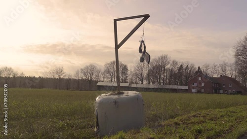 Pair Of Rubber Boots Hanging Over The Field At Sunset During Farmers' Protest In Rhineland-Palatinate, Germany. wide shot photo