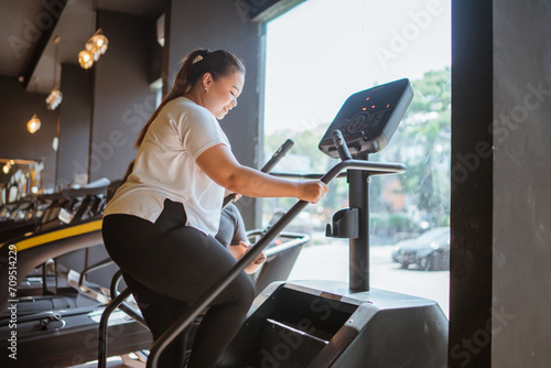 plus size woman doing fitness for weight loss program in gymnasium