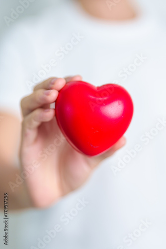 Fototapeta Naklejka Na Ścianę i Meble -  hand holding red heart shape in hospital. love, donor, world heart day, world health day, CSR donation and Insurance concepts