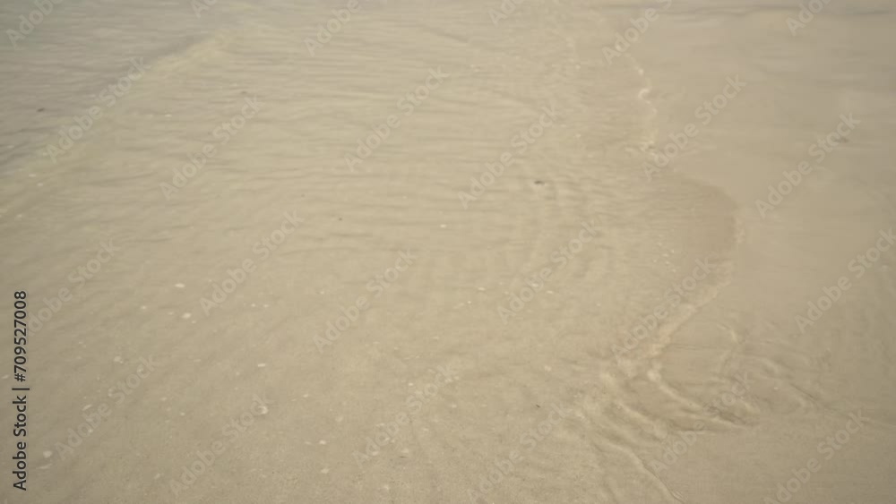 ocean waves calmly glide through the sand 4K UHD ocean waves calmly glide through the sand 4K UHD