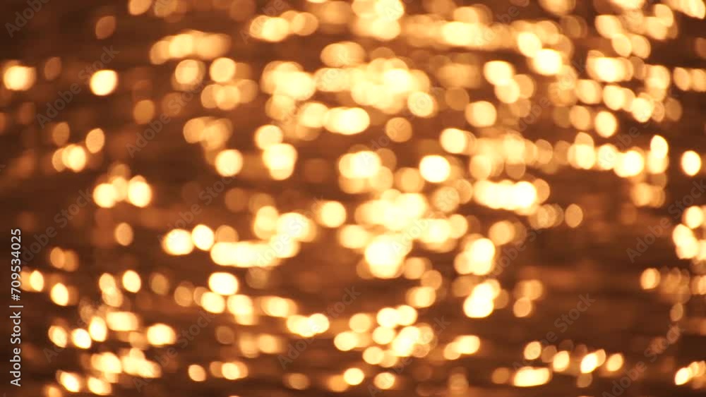 Abstract Blurred video screensaver bokeh golden sea at sunset. The sun reflects and sparkles on the waves. Abstract Blurred video screensaver bokeh golden sea at sunset. The sun reflects and sparkles on the waves.