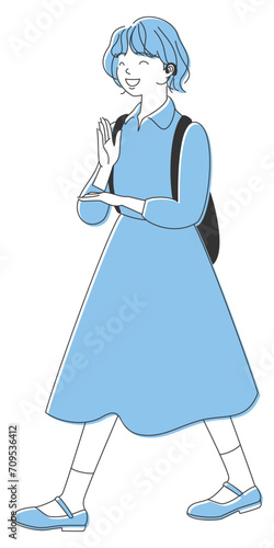 手話で「ありがとう」をしながら歩く聾の女の子