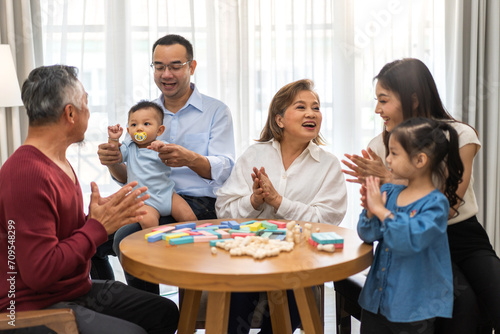 Portrait of happy love family asian father and mother playing with adorable asian baby and sister girl.newborn, infant.mom touching with cute son moments good time with grandparents.Love of big family © Art_Photo