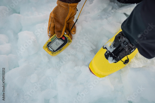 Photography Person holding a modern avalanche beacon in his hands