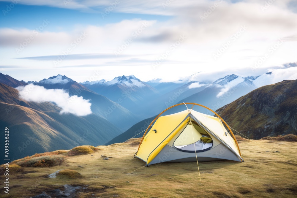 tent pitched on a ridge with panoramic mountain view