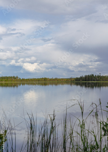 Beautiful and calm scenery at the lake shore on a cloudy day in Finland.