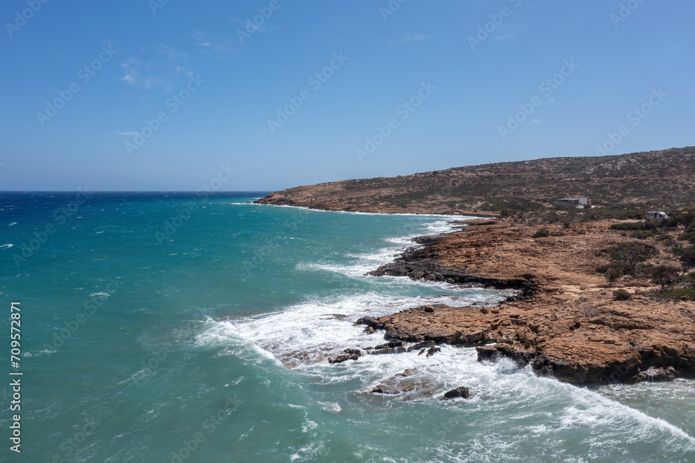 Crete, Gavdos island Greece. Aerial drone view of rocky beach, wild landscape, sea, blue sky, nature Crete, Gavdos island Greece. Aerial drone view of rocky beach, wild landscape, sea, blue sky, nature