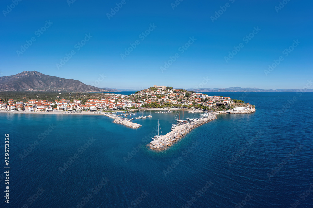 Paralio Astros port, Arcadia, Peloponnese Greece. Aerial drone panoramic view of town, moored boat.